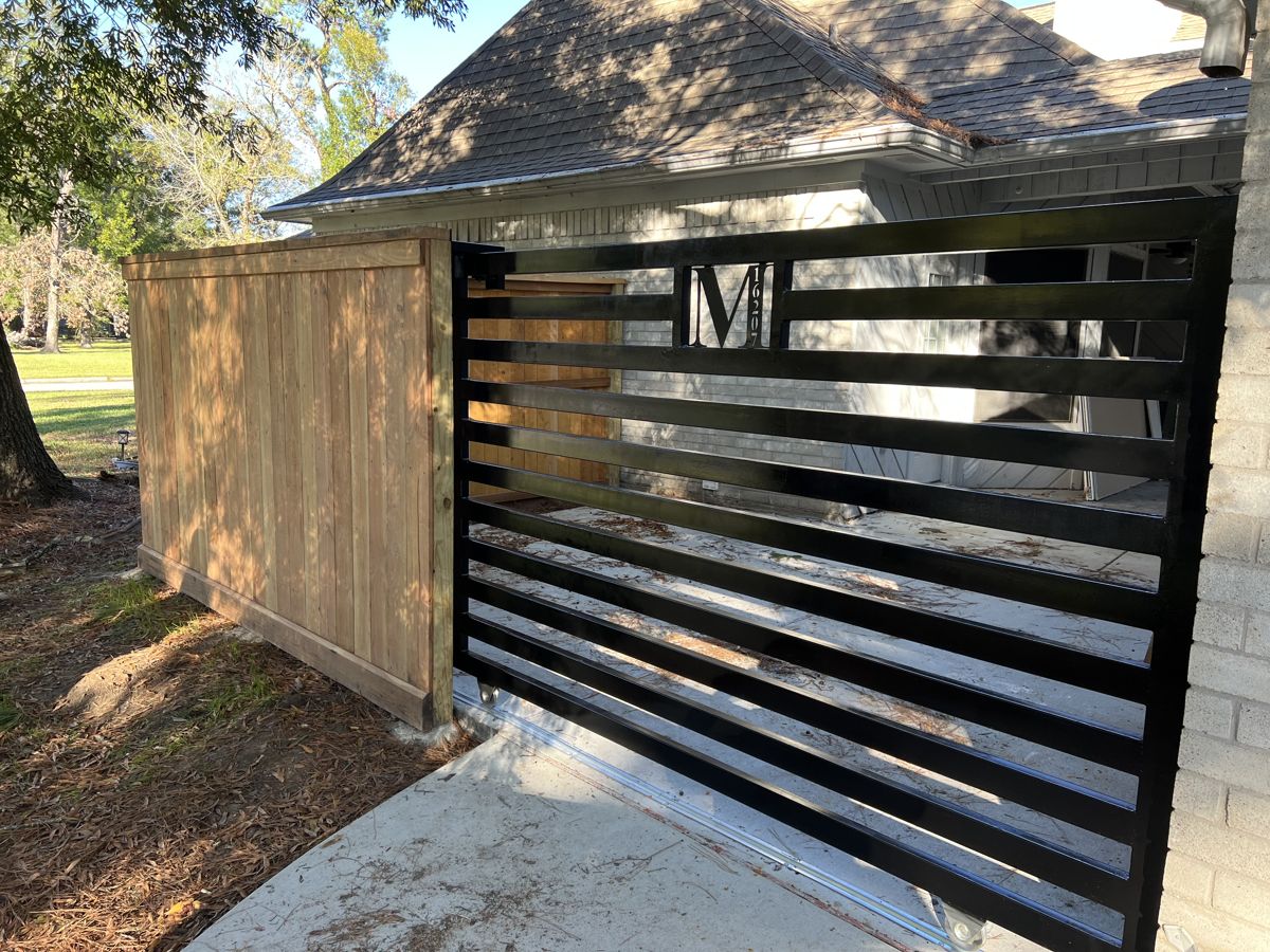 Custom black slat driveway gate